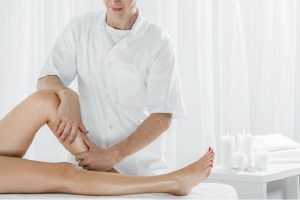 57023772 - professional masseur doing manual lymphatic drainage, light interior