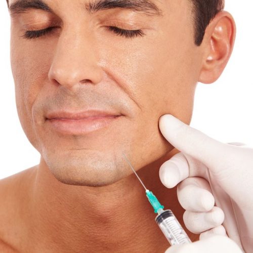 13713185 - attractive man at plastic surgery with syringe in his face