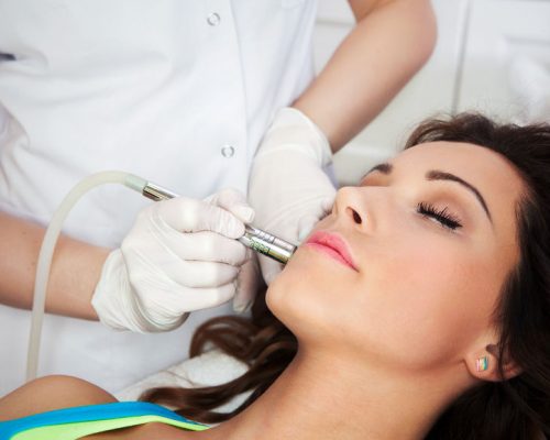 26245270 - woman getting laser face treatment in medical spa center, skin rejuvenation concept